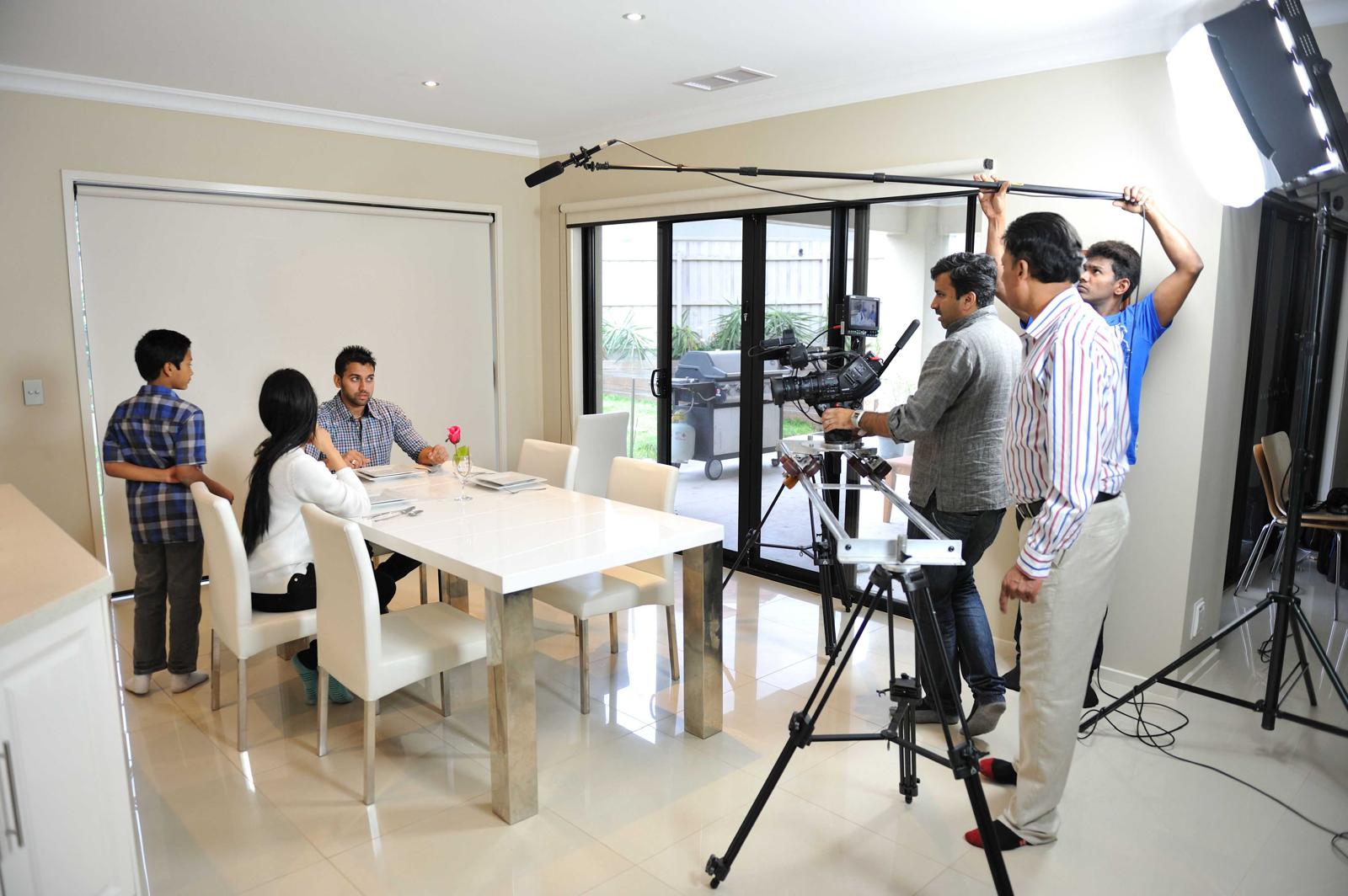 Magic Frames studio with professional film crew shooting a dining scene with camera jib
