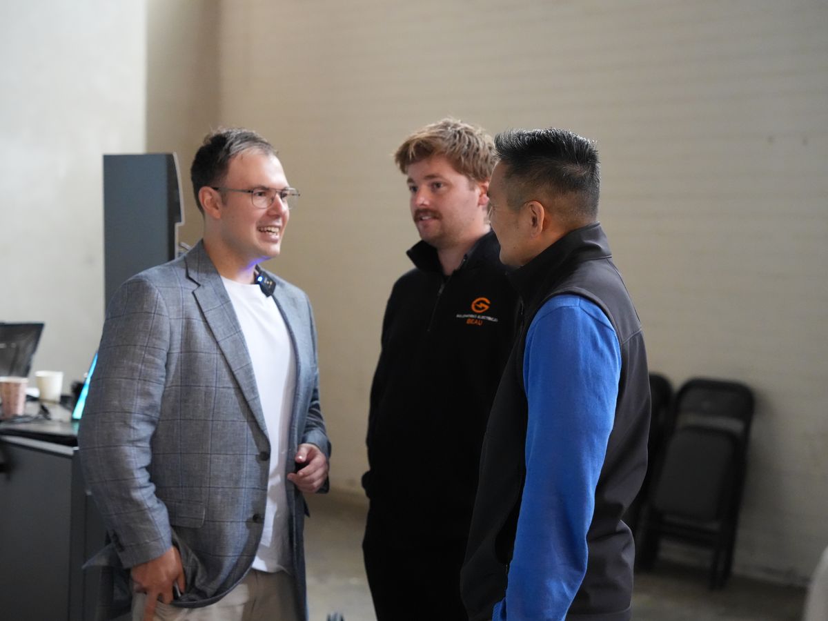 Three business owners talking between sessions
