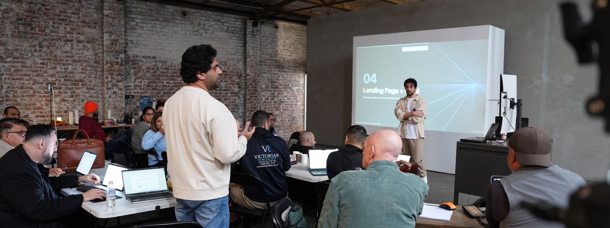 An attendee standing to ask a question while the landing page section is on screen